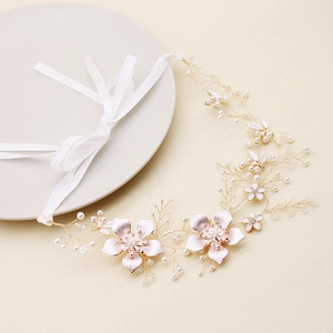 Détail macro d'un accessoire cheveux mariée fait main avec perles et ruban blanc