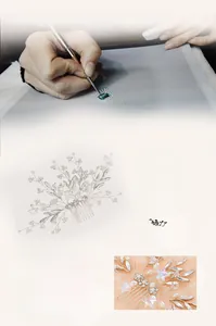Macro detail of handmade bridal hair comb featuring ceramic flowers and starfish with pearls