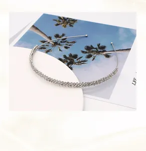 Macro shot of handmade silver copper wire headband with three rows of sparkling rhinestones