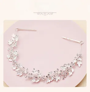 Detailed view of silver leaf bridal headband with sparkling rhinestones and hair clips