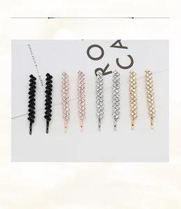 Detail of vine-shaped hair clips with sparkling rhinestones in four elegant colors