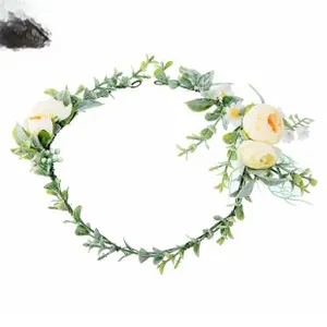 Detail of bridal floral wreath with deep green leaves and white orange silk flowers