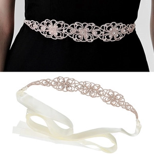 Detailed close-up of handmade rose gold bridal belt with floral rhinestones and ivory ribbon
