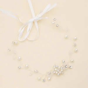 Detailed view of bridal rhinestone belt with pearls and white satin ribbon for wedding dress