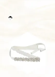 Detailed macro view of handmade crystal rhinestone floral applique on bridal belt sash