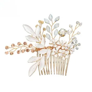 Detail of handmade bridal hair comb with white enamel flowers and pearls on gold base