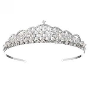 Macro detail of silver tiara showing intricate clear rhinestone inlay and star motif