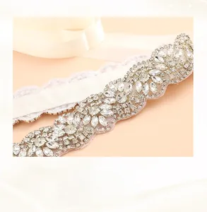 Detailed macro view of handmade crystal bridal sash featuring copper wire and rhinestones