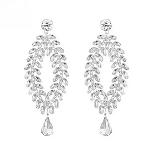 Detailed view of silver bridal dangle earrings with leaf crystals and teardrop pendants