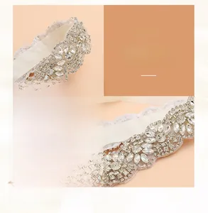 Close-up detail of handcrafted rhinestone bridal appliqué with intricate floral lace pattern