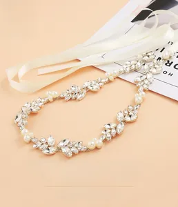 Detailed view of luxury bridal sash with marquise rhinestones and white pearls on cream ribbon