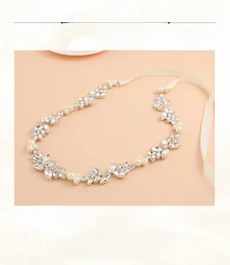 Macro detail of rhinestone and pearl bridal headband with elegant satin ribbon