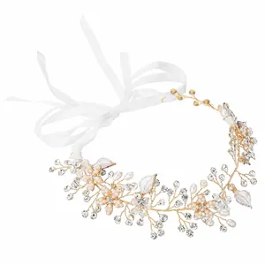 Elegant gold bridal hairpiece with pearl flowers, crystals, and white ribbon tie