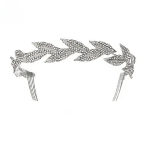 Detailed view of silver bridal crown with crystal-encrusted metal leaves and side hair combs