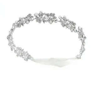 Detail of silver leaf bridal tiara featuring sparkling rhinestones and white silk ribbons