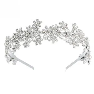 Detailed close-up of bridal tiara featuring silver metal leaves and sparkling rhinestones