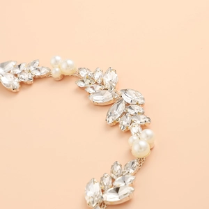 Luxurious rhinestone and pearl leaf belt accessory in a gold finish for wedding dresses