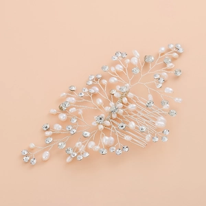 Handmade silver bridal hair comb with freshwater pearls and rhinestones on pink background