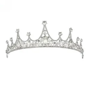 Close-up of silver bridal crown with intricate metal leaf design and inlaid white rhinestones