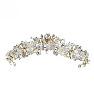 Detailed close-up of golden leaf crown with white faux pearls and clear rhinestones