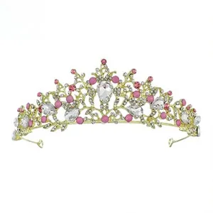 Detail of golden princess crown with pink beads and large pear-shaped rhinestones