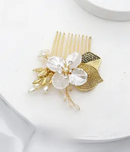 Détail du peigne à cheveux de mariée avec pétales dorés, perles et accents en cristal