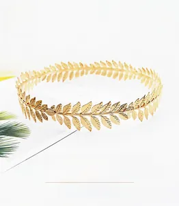 Detailed macro shot of a golden metal olive leaf tiara with polished finish for weddings