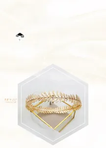 Detail of golden leaf bridal tiara with fine vein textures on a glass display box