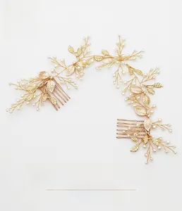 Detailed close-up of golden bridal hair combs with white pearls and metal leaf design