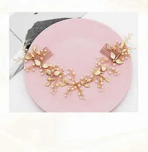 Detail view of handmade gold bridal hair comb with pearls and golden leaves