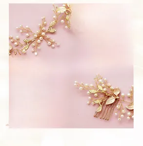 Detail of handcrafted gold hair comb with pearls and metal leaves for wedding hairstyles