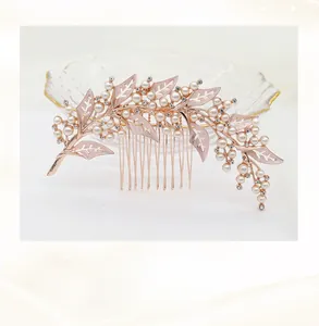 Close-up of handmade rose gold hair comb with hollow leaves and white pearls