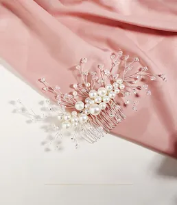 Detailed view of handmade bridal hair comb with pearls and crystals on silver wire