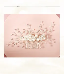 Detailed close-up of handmade bridal hair comb with pearls and crystals on silver wire