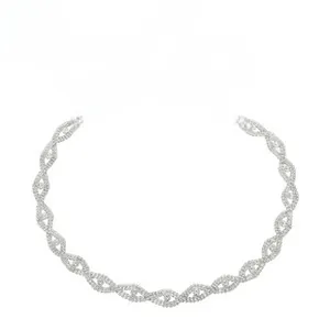 Detailed view of silver rhinestone chain belt with white ribbon bow for formal dresses