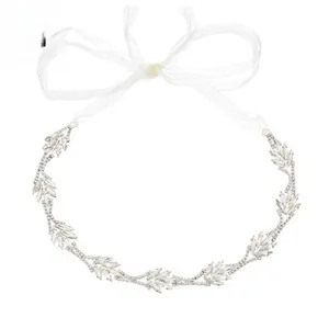 Close-up of bridal headband featuring silver rhinestone leaves and white organza ribbon ties