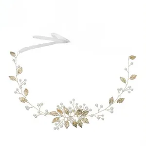 Detailed bridal hairpiece featuring gold metal leaves and elegant white faux pearls