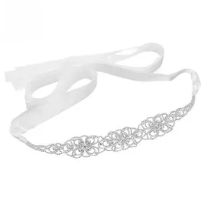Detailed view of luxury bridal belt featuring sparkling rhinestone flowers on white satin ribbon