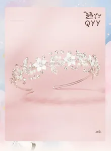 Detail of silver bridal headband with white flowers, pearls, and rhinestones