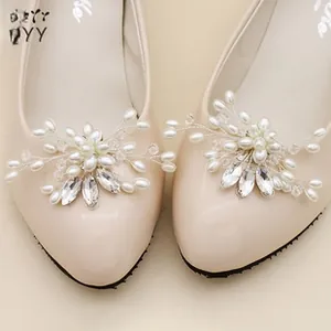Detail of luxury bridal shoe clip featuring sparkling pearls and rhinestones flower design
