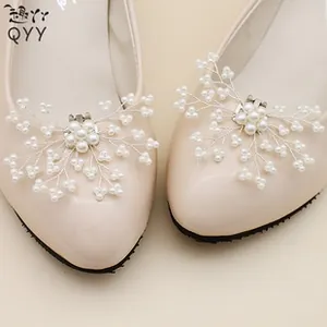 Close-up of pearl flower shoe buckles on beige patent leather wedding flats