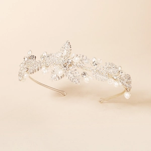 Macro shot of silver bridal headband with intricate crystal clusters and white pearls
