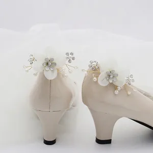 Beige patent leather bridal pumps with delicate handmade fabric flower and pearl charm