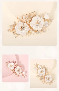 Macro detail of white floral hair comb with pearls and golden leaves for bridal wedding hair