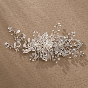 Exquisite bridal hair comb with alloy flowers and sparkling crystals on dark background