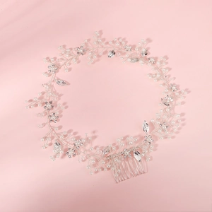 Elegant bridal hair comb featuring pearls, rhinestones and silver leaves for wedding styling