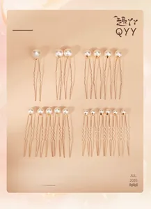 Detailed flat lay of an 18-piece golden U-shaped hair pin set with white pearls