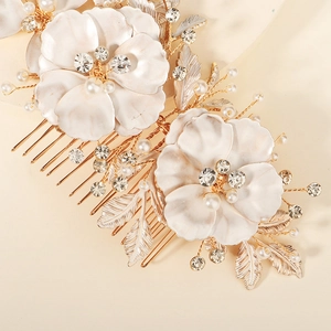 Elegant gold flower hair comb with white pearls and crystals for bridal hair styling