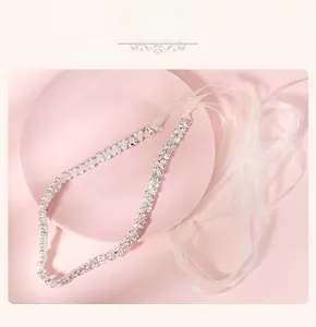 Détail d'une ceinture en strass étincelante avec rubans en mousseline blanche sur plat rose