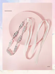 Vue détaillée de la ceinture de mariée avec fleurs en strass et ruban en satin blanc pur